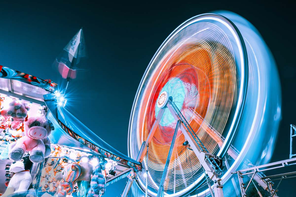 ferris wheel time-lapse photography of Ferris wheel at night theme park